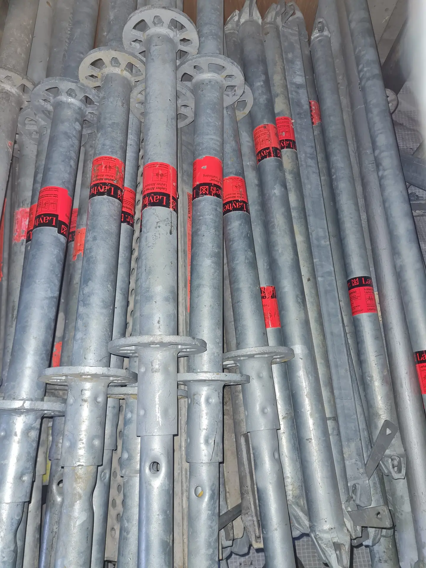 Layher-scaffolding-tubes-stacked-scaled